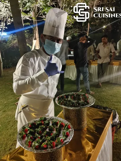 The skills of our hotel management trained staff extend to our specialty stations. Here, a team member in a full chef's uniform is preparing paan, demonstrating the versatility and professional training our crew brings to every aspect of your event's food service.