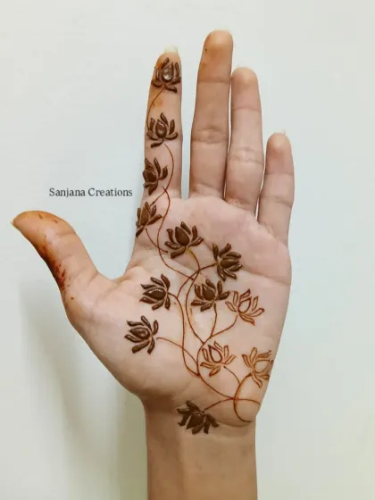 The design in its early stages, showing the light stain of the fresh henna paste.