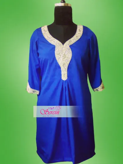 A royal blue short kurta with detailed silver zardozi work on the v-neckline and cuffs. This is a simple yet striking piece that can be paired with trousers or a palazzo for a complete festive look.