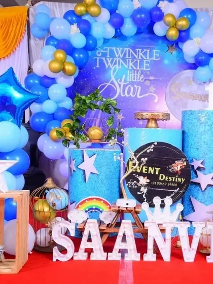 A full view of the "Twinkle Twinkle Little Star" decor, showing the themed pedestals, marquee letters, and star-shaped balloons that complete the look.