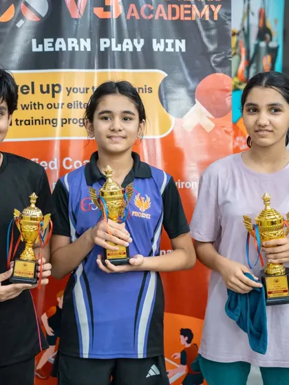 The girls' category winners holding their trophies high. I am committed to fostering female talent and creating strong competitors in the sport.