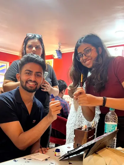 A duplicate of the group getting creative with a painting activity organized by our host club in Pune.