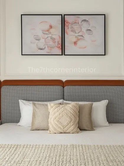 A full view of the master bedroom, showing the balance between the bold headboard, the abstract art, and the classic wall mouldings. Gold accents on the wall sconces add a touch of opulence.