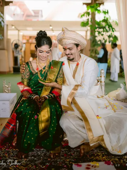 A candid moment during the wedding rituals, with the couple sharing a gentle interaction.