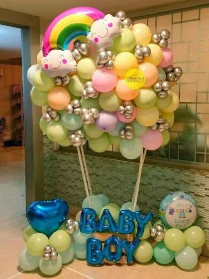 A colorful hot air balloon bouquet for a baby boy's welcome. The pastel rainbow colors and cloud details make this a cheerful and uplifting decoration.