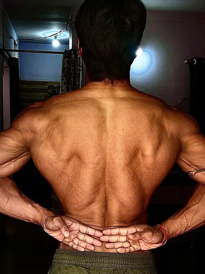 A back pose with hands clasped, symbolizing the release of old habits and the embrace of a new, stronger self.