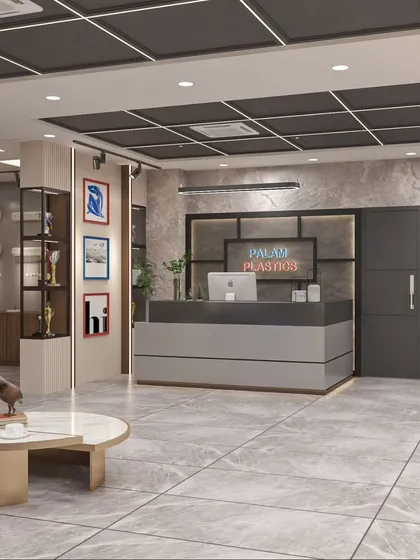 The reception area for Palam Plastics, featuring a modern grey desk, marble-look flooring, and a display area for awards, creating a strong first impression.
