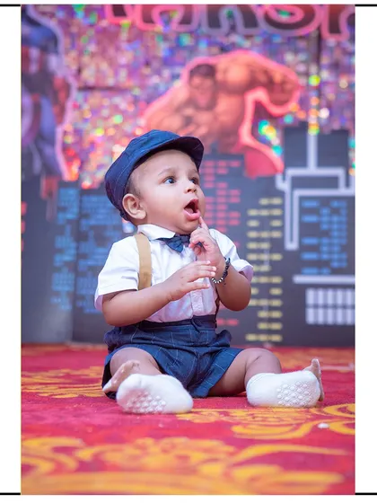 A curious look from this little boy during his superhero-themed photoshoot. The dynamic background adds a lot of energy to the portrait.