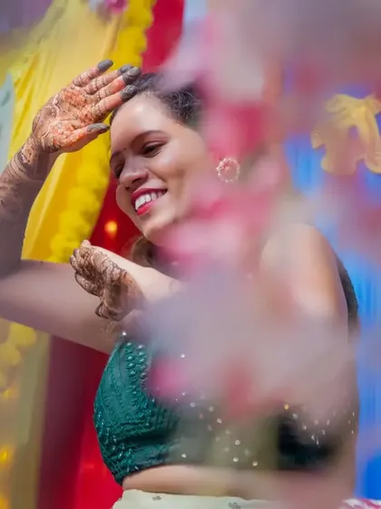 A candid shot of the bride dancing and enjoying her mehendi ceremony to the fullest.