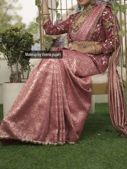 A creative shot showing the beautiful drape of the saree. The overall look is one of grace and timeless elegance.