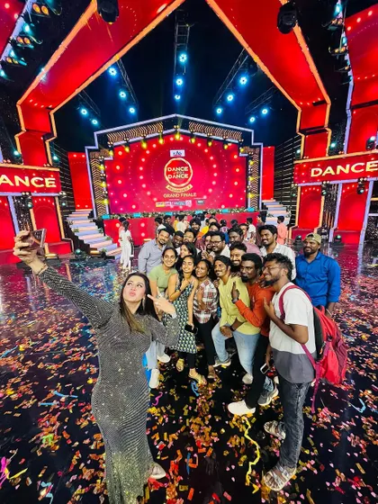 A group selfie with judge Sangitha Krish ma'am and the entire crew on the confetti-filled stage of 'Dance Jodi Dance Reloaded 2'.