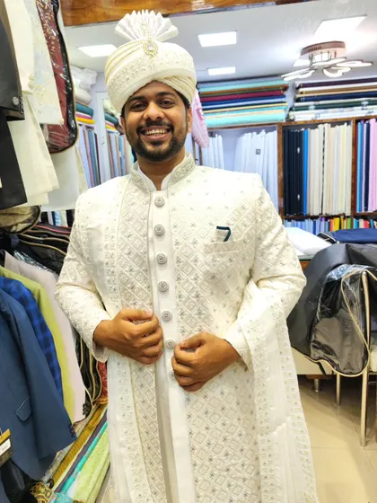 A happy client in his custom white embroidered sherwani, giving a thumbs up in my studio. It's always rewarding to see a client so pleased with the final result.