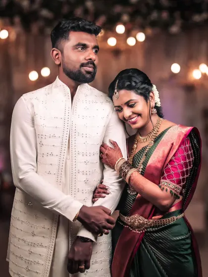 A beautiful portrait of a South Indian couple. The bride rests her head on the groom's shoulder, and their comfortable, happy expressions show the deep bond they share.