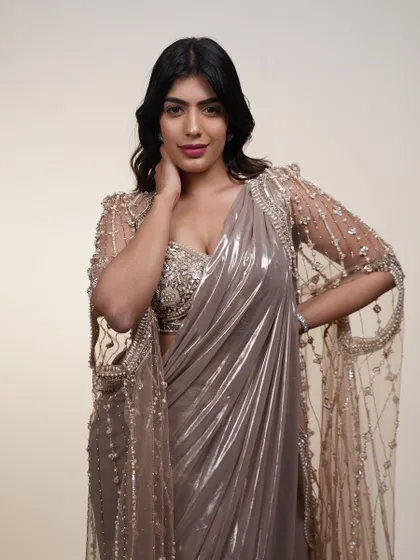 Another view of the metallic saree with its embroidered cape. This is a look that guarantees a grand entrance.
