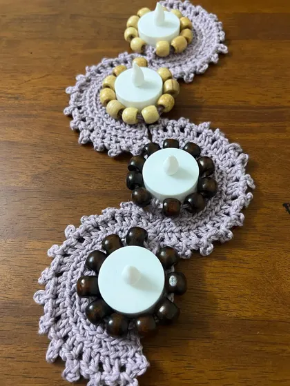 My beaded tealight runner, unlit, showing the beautiful craftsmanship of the crochet work and the contrast between the wooden beads.