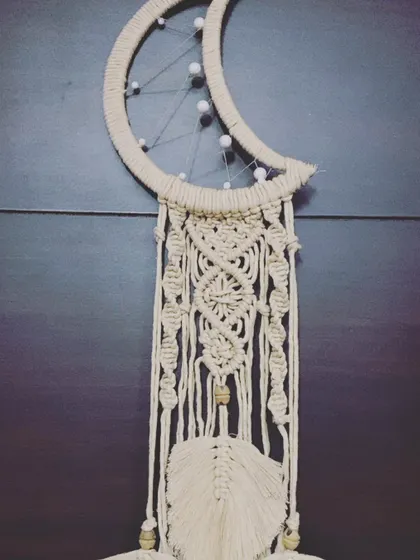 A full view of another version of the moon dreamcatcher, this one featuring a more complex central pattern.