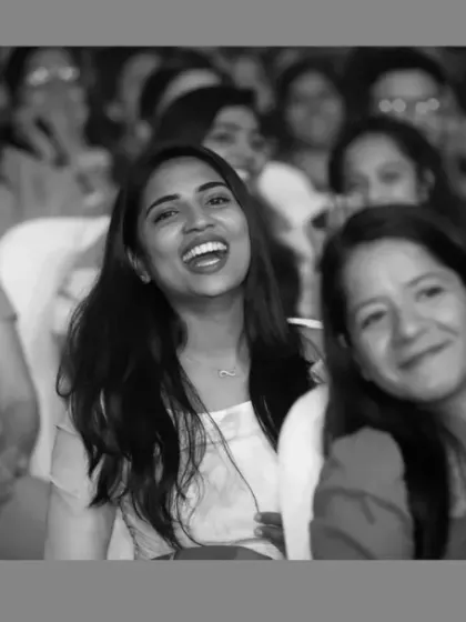 A black and white photo capturing the joyful reactions of audience members. This artistic shot focuses purely on the emotion and shared experience of the attendees, creating a timeless memory of the event.