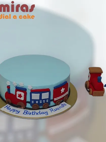 All aboard the birthday express! This simple and cute train cake is perfect for a third birthday, featuring a little red and blue train chugging along the side.