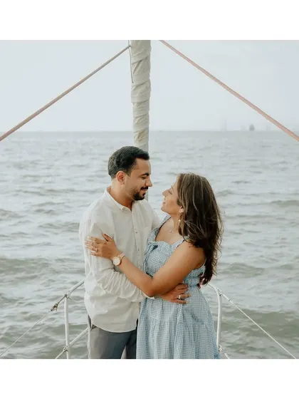 A classic romantic pose on the bow of a yacht, with the endless sea creating a beautiful, clean backdrop.