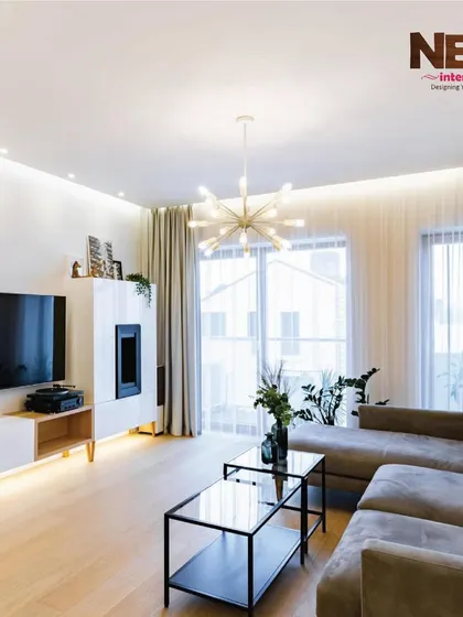 This living room setup shows a clean and bright aesthetic, achievable through smart lighting, light-colored walls, and modern furniture.