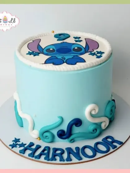 A cute and simple Stitch-themed cake. This light blue cake features the adorable alien and wave-like decorations, perfect for a fan of Lilo & Stitch.