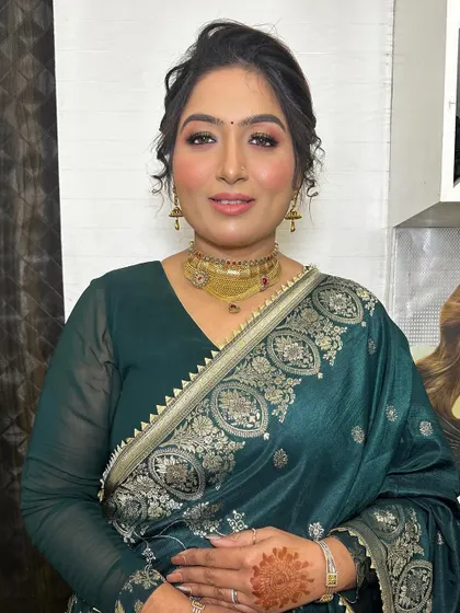 A beautiful, simple party look. The focus is on her glowing skin and a soft, elegant eye makeup that enhances her natural features.