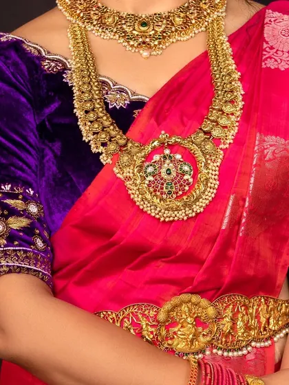 A detailed shot of the temple jewellery set, including the choker, haram, and vaddanam.