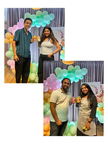 Happy couples at a baby shower, posing with the art they created. Adding a creative element to a party makes it even more engaging and memorable.