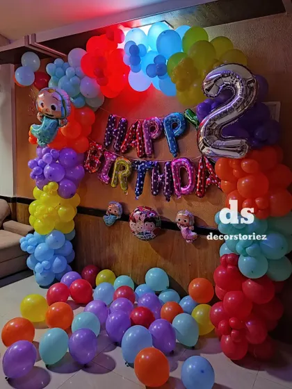 A colorful Cocomelon theme for a second birthday. This vibrant balloon arch uses all the signature colors from the show and features character foils to bring the theme to life.