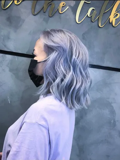An ash hair transformation resulting in this beautiful, wavy, silver-blue lob. The color is unique, modern, and full of dimension.