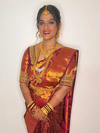 A smiling bride looking radiant on her wedding day. The makeup is classic and timeless, with a focus on glowing skin and a beautiful smile.