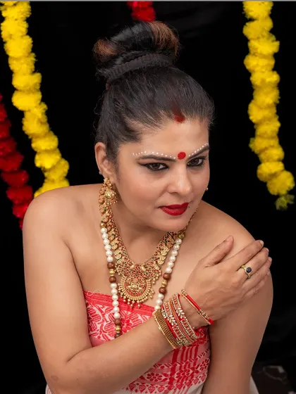 Another view of the Onam fusion look, showing the high bun and the contrast between the Assamese fabric and Karnataka jewels.