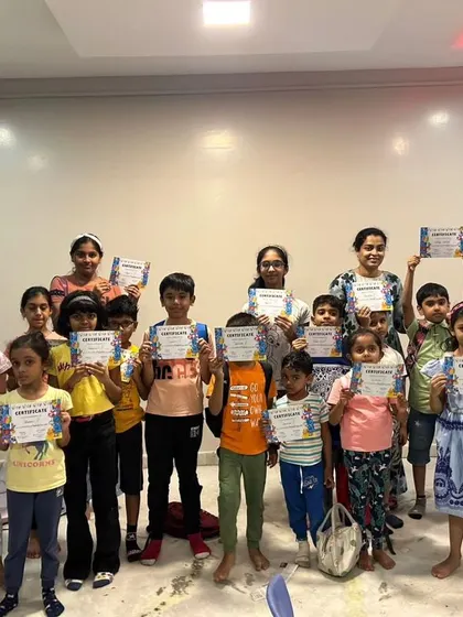 A group photo of our summer camp graduates, all proudly displaying their certificates of completion.