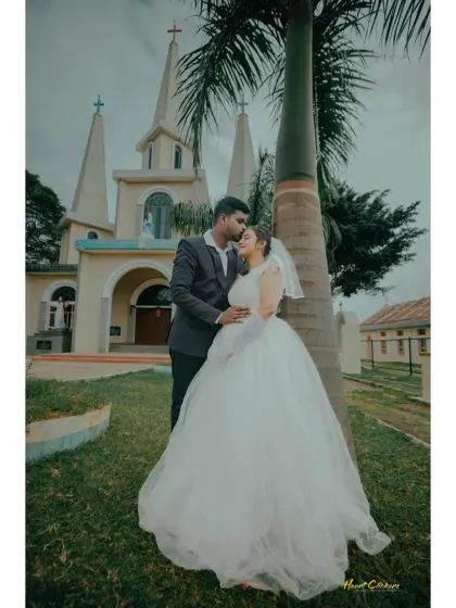 A romantic Christian wedding portrait. The groom's kiss on the bride's forehead is a classic expression of love and affection.