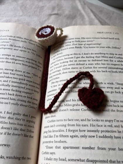 For my fellow bookworms, a handmade crochet bookmark designed to look like a tiny cup of coffee with a heart charm.
