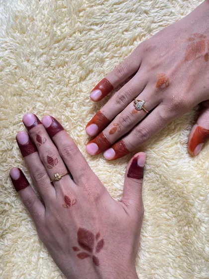 A side-by-side comparison of a fresh, orange-toned henna stain and a mature, deep red stain using simple leaf motifs.