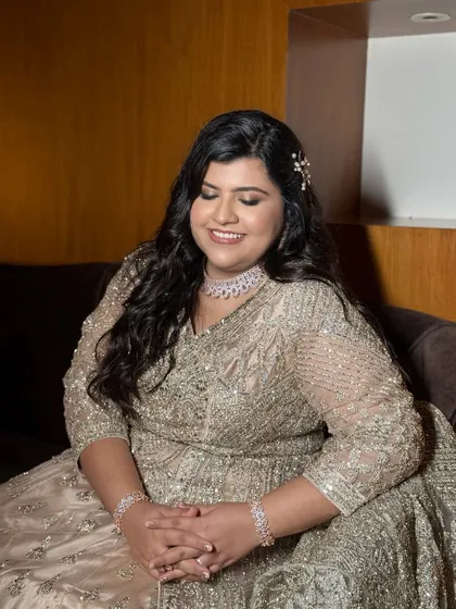 A serene, smiling portrait. The makeup is designed to enhance her natural beauty and celebrate who she is.