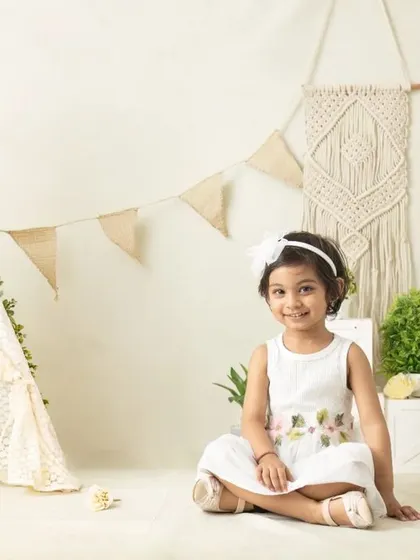 My boho-themed sessions use natural textures like macrame, wood, and greenery to create a calm and earthy setting that beautifully complements your child's simple joy.