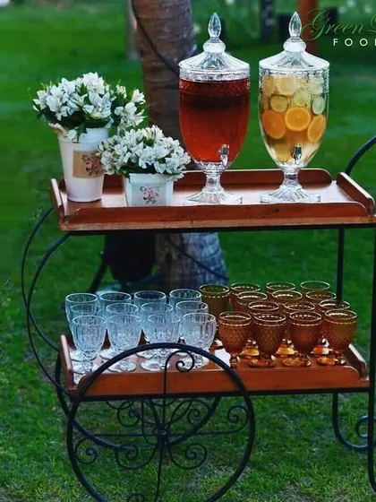 Our beverage cart is a charming addition to any outdoor party. It comes stocked with beautiful glassware and dispensers of colorful, fresh juices, creating an inviting and stylish drink station.
