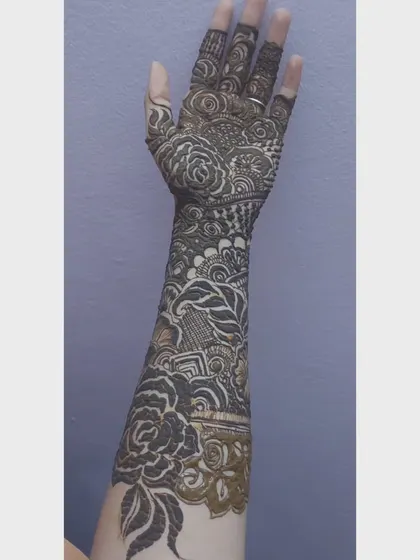 The same intricate bridal arm design, shown from a slightly different angle. The fine line work and shaded details are clearly visible in this shot.