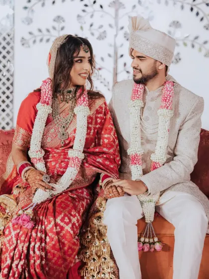 A moment of quiet connection. The couple seated together after their ceremony, sharing a look of love.