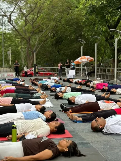 A moment of collective rest in Savasana during our outdoor International Yoga Day event. Even in a large group, finding stillness together is a powerful and unifying experience.