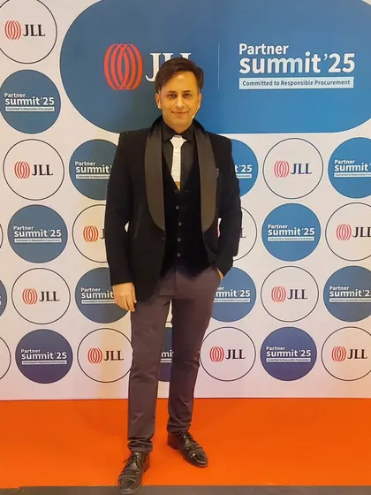 Posing at the JLL Partner Summit. The branding and event setup were top-notch, providing a great backdrop for my performance.
