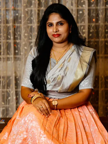 A relaxed portrait of a wedding guest, beautifully lit against a warm indoor background. I make sure to capture the friends and family who share in your joy.