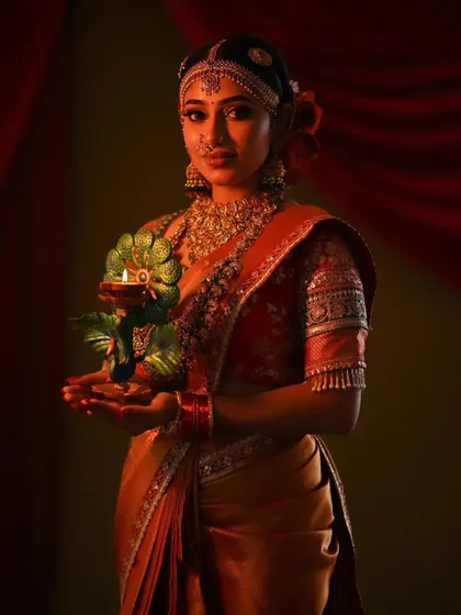 A duplicate of the previous image, this shot continues to highlight the rich, warm tones of the festive bridal look.