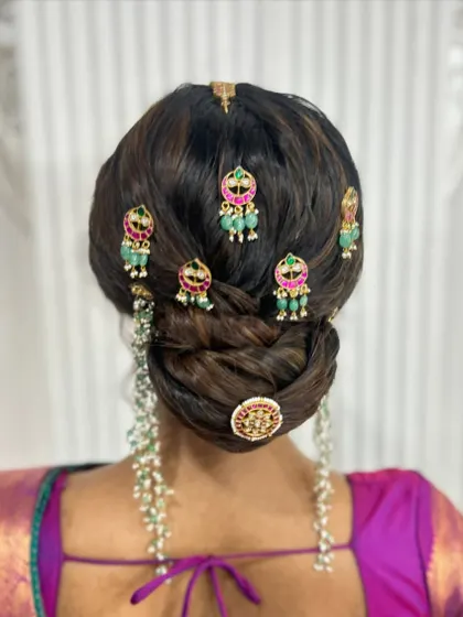 A clear back view of the stunning jewellery-adorned updo, a perfect choice for a bride wearing a silk saree.