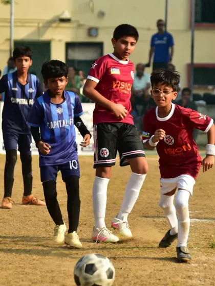 A young player races towards the ball, showing the energy and enthusiasm our teams bring to every match.