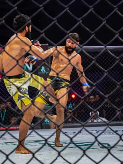 A leg kick lands in the title fight between Sanjeet Budhwar and Shyamanand. This fight is a must-watch for anyone new to Indian MMA.