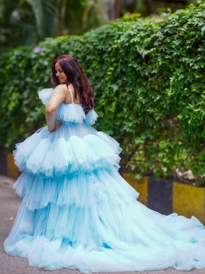 The back view of the blue ruffle gown shows off its impressive trail, which adds drama and elegance to every step.