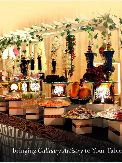 An elaborate dessert and fruit buffet set under a decorative trellis. This image showcases how we bring culinary artistry to your table with stunning, multi-layered presentations.